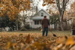 Madcow Tree Service—A man stands in his yard in Edwardsville, IL, among the fall leaves before cleanup.