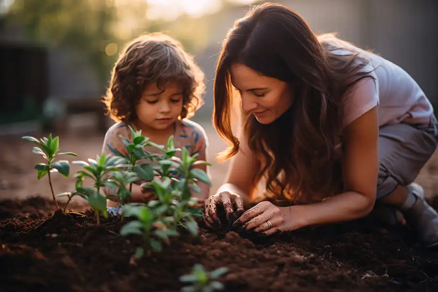 Madcow Tree Service—A young mother and her child plant a tree in their Alton, IL backyard.